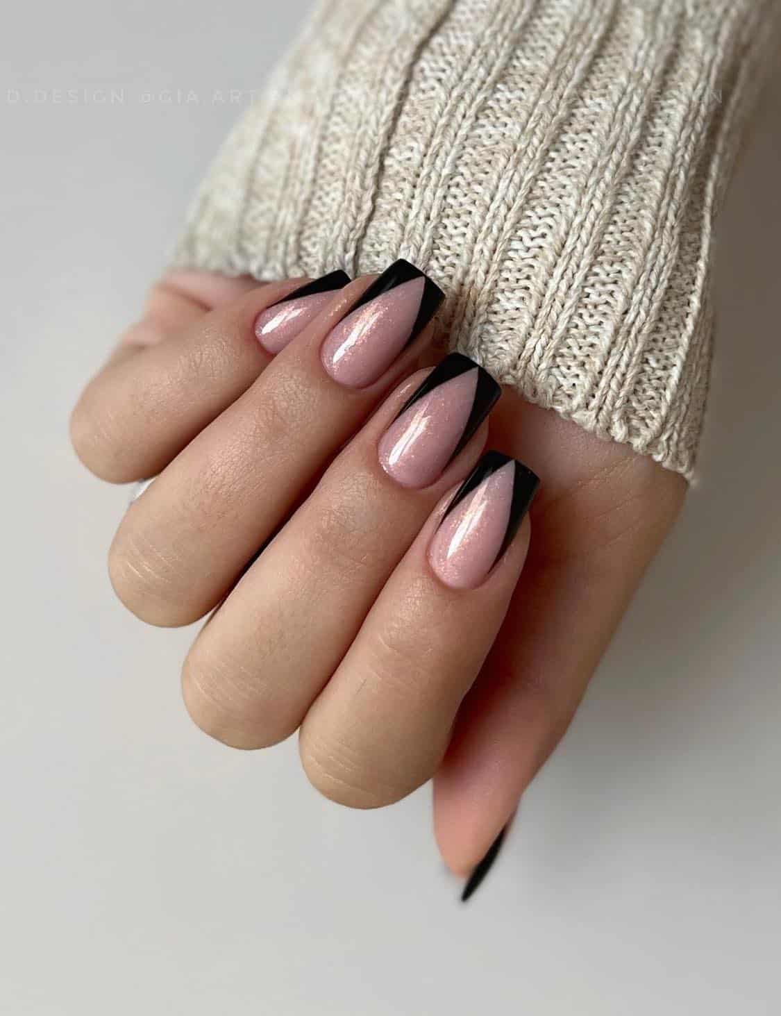 Medium square nails with shimmering nude pink polish and pointed black French tips