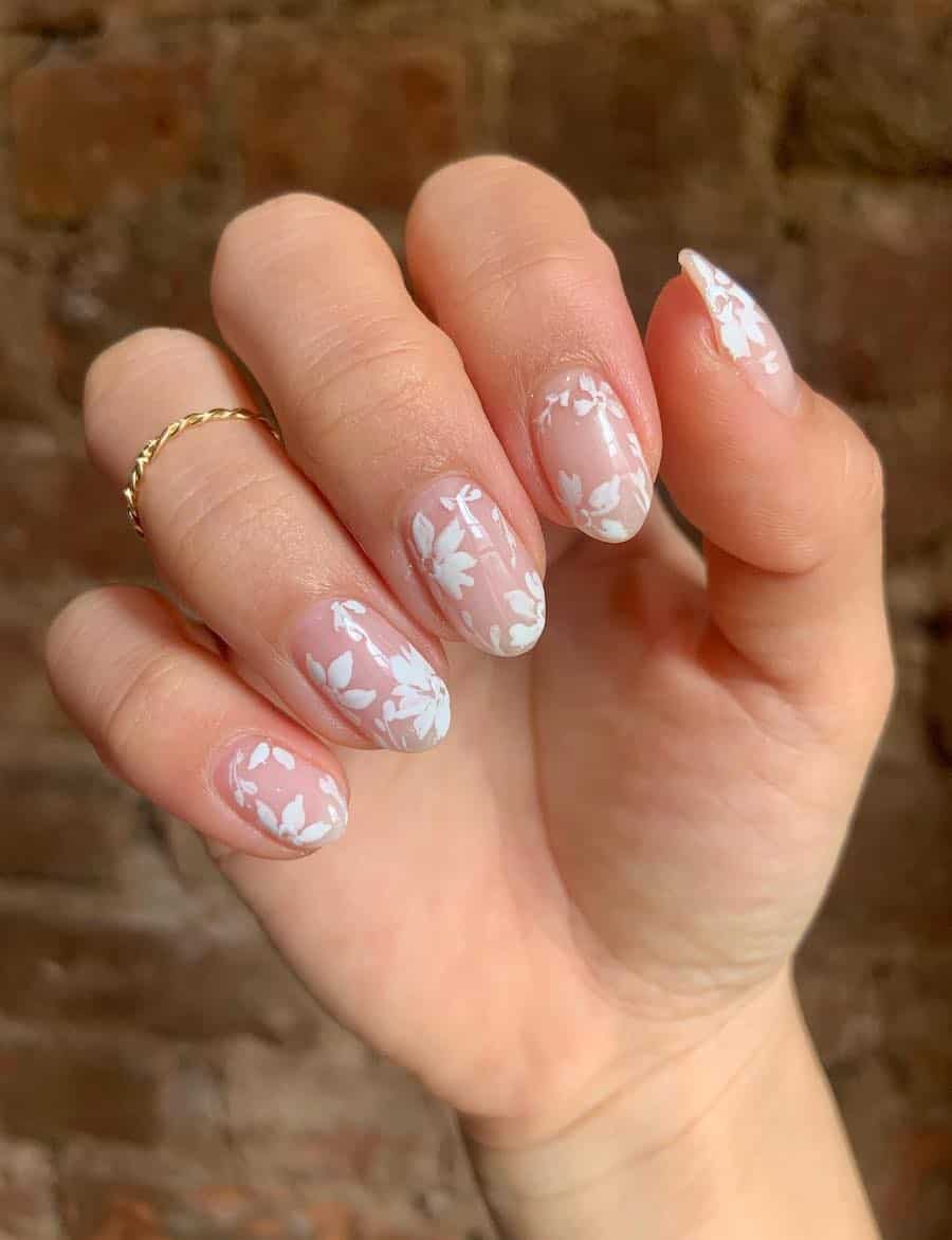 Short almond nails with white floral nail art