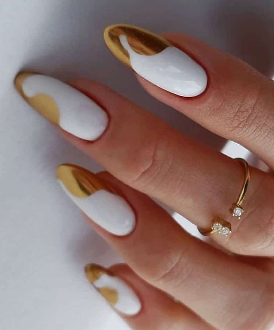 Long white almond nails with wavy gold French tips