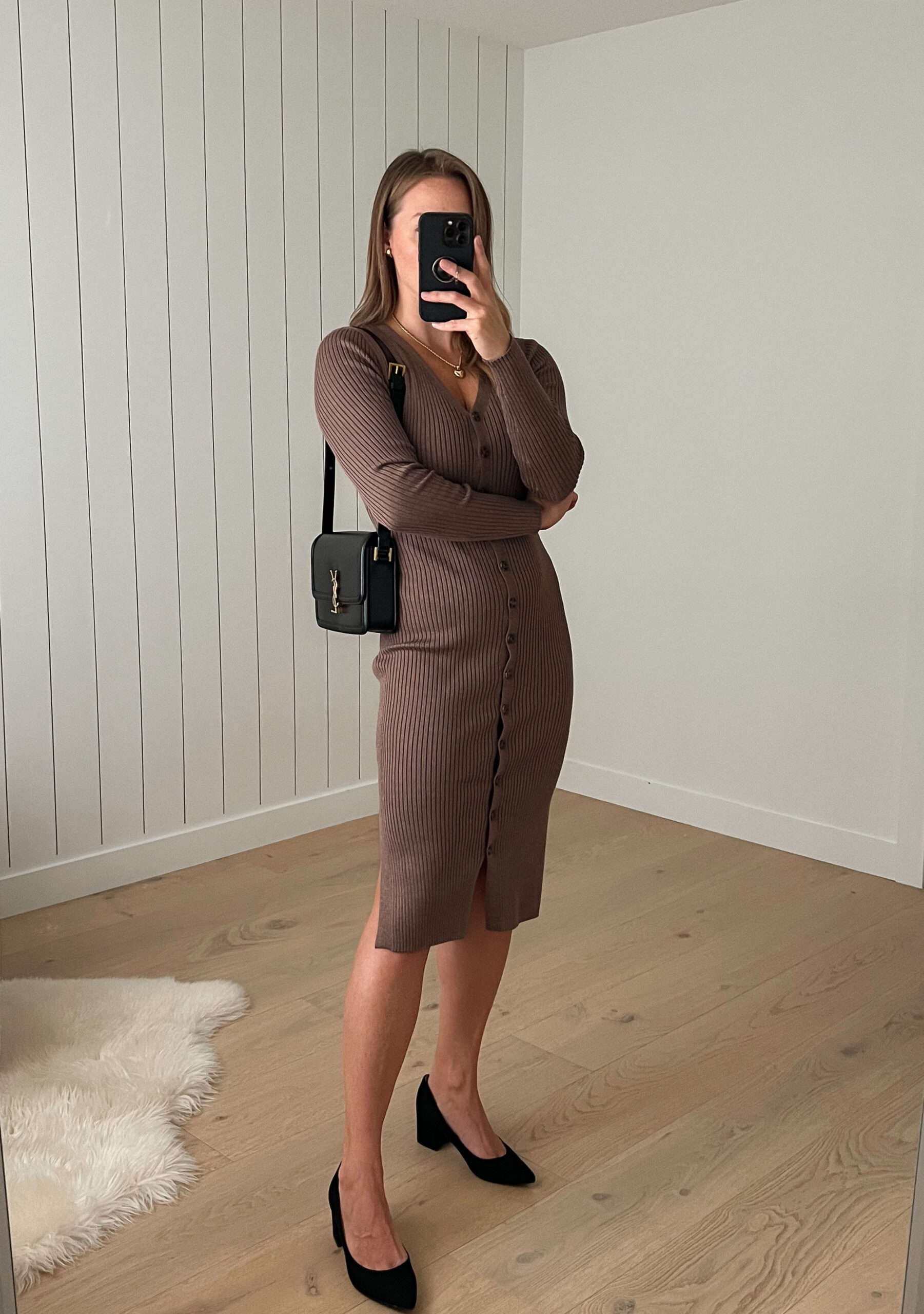 Woman wearing a brown knee length sweater dress with heels.