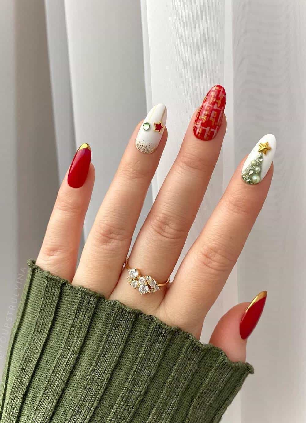 Red and white Holiday manicure with a green Christmas tree detail and star jewels.
