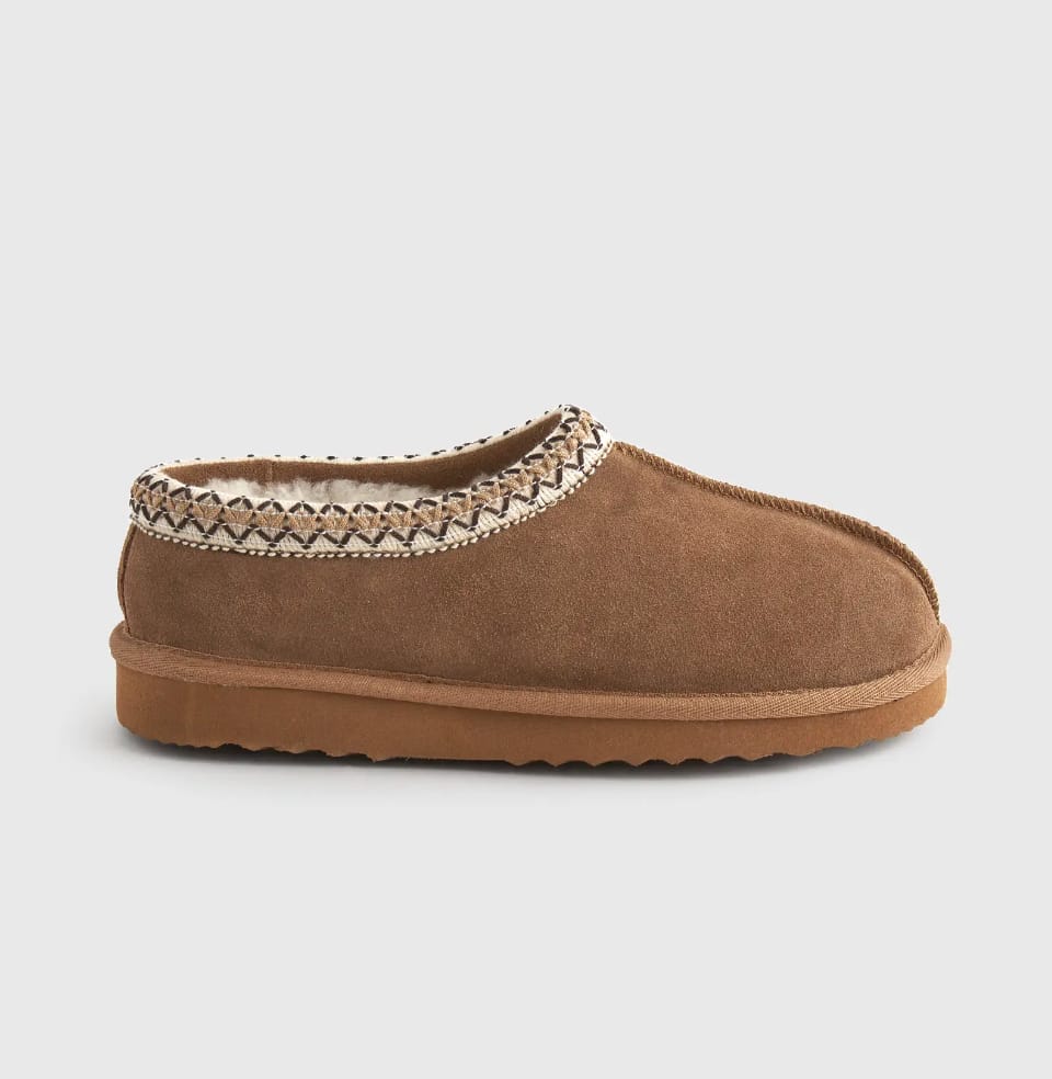 image of a shearling slipper with stitching around the edge that is a dupe of the Ugg Tasman slipper