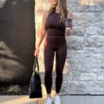 Christal wearing a brown Neiwai tank top with matching brown Neiwai leggings and white sneakers
