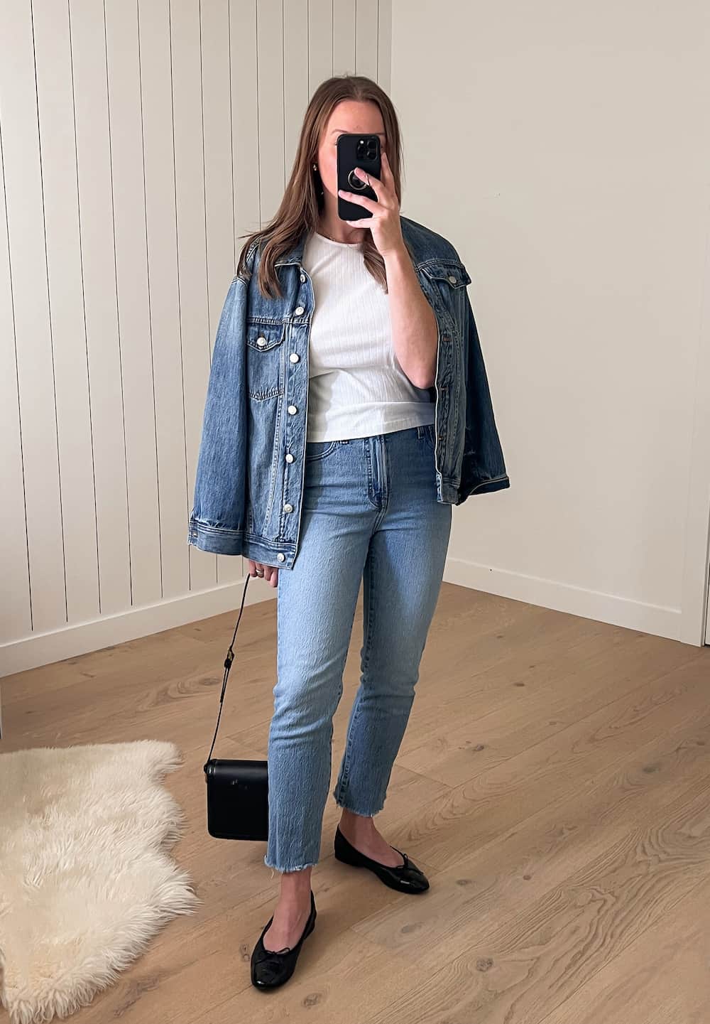 Christal wearing an oversized Madewell denim jacket with a white tee and Madewell blue jeans