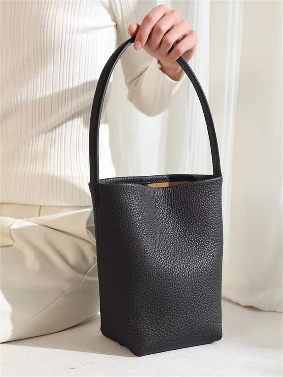 A black leather The Row tote bag dupe from Etsy