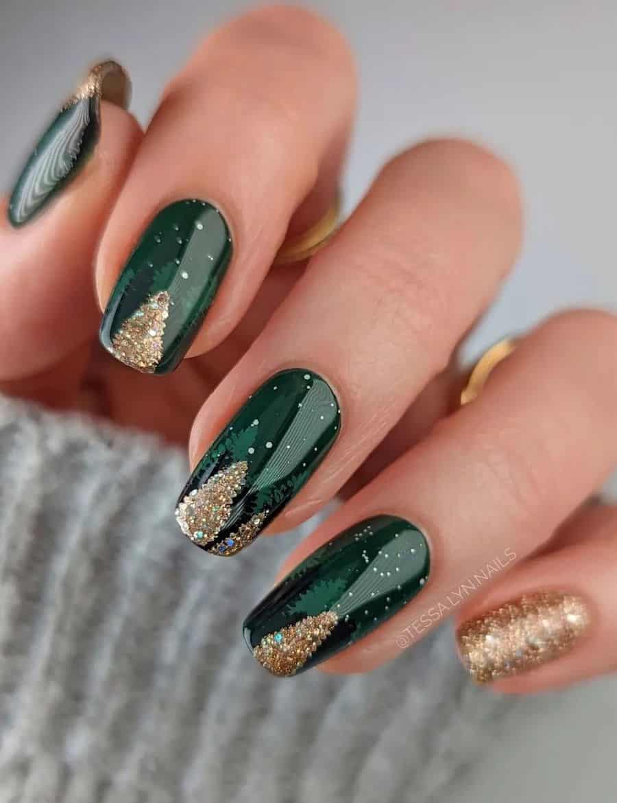 A hand with short squoval nails painted a dark green with glittery gold pine tree art and a gold accent nail