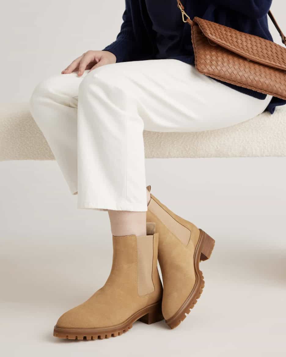 woman wearing white pants with tan suede Chelsea boots