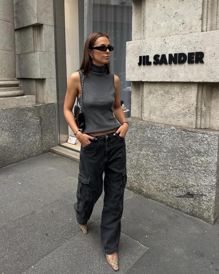 Woman wearing black cargo pants with a turtleneck tank top and pointed toe slingback heels.