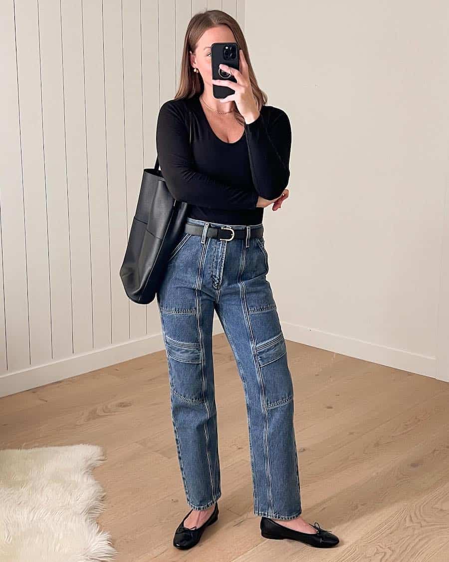 Christal wearing cargo jeans with black ballet flats, a black knit top and black accessories.