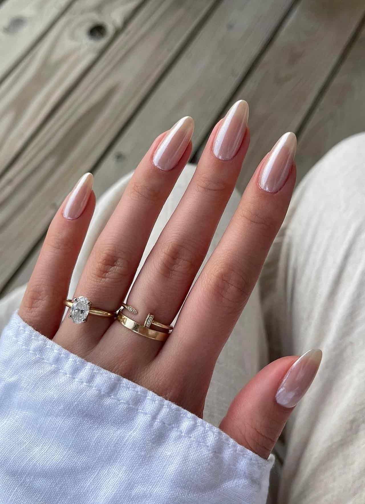 A hand with medium white chrome almond nails