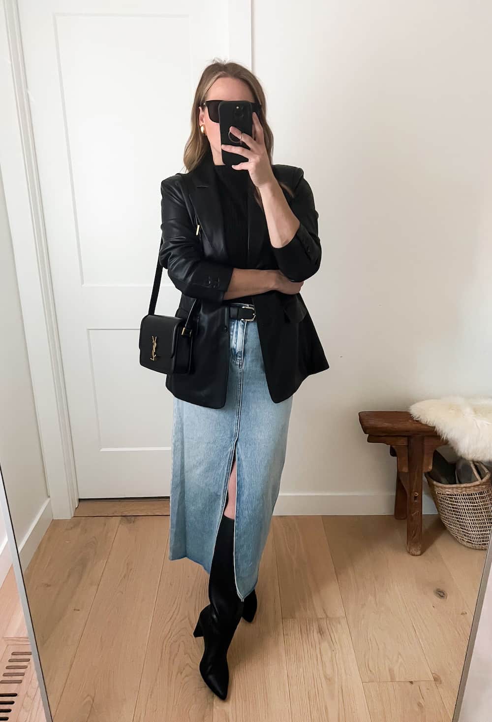 Christal wearing a long denim skirt with tall black boots and a black leather jacket.