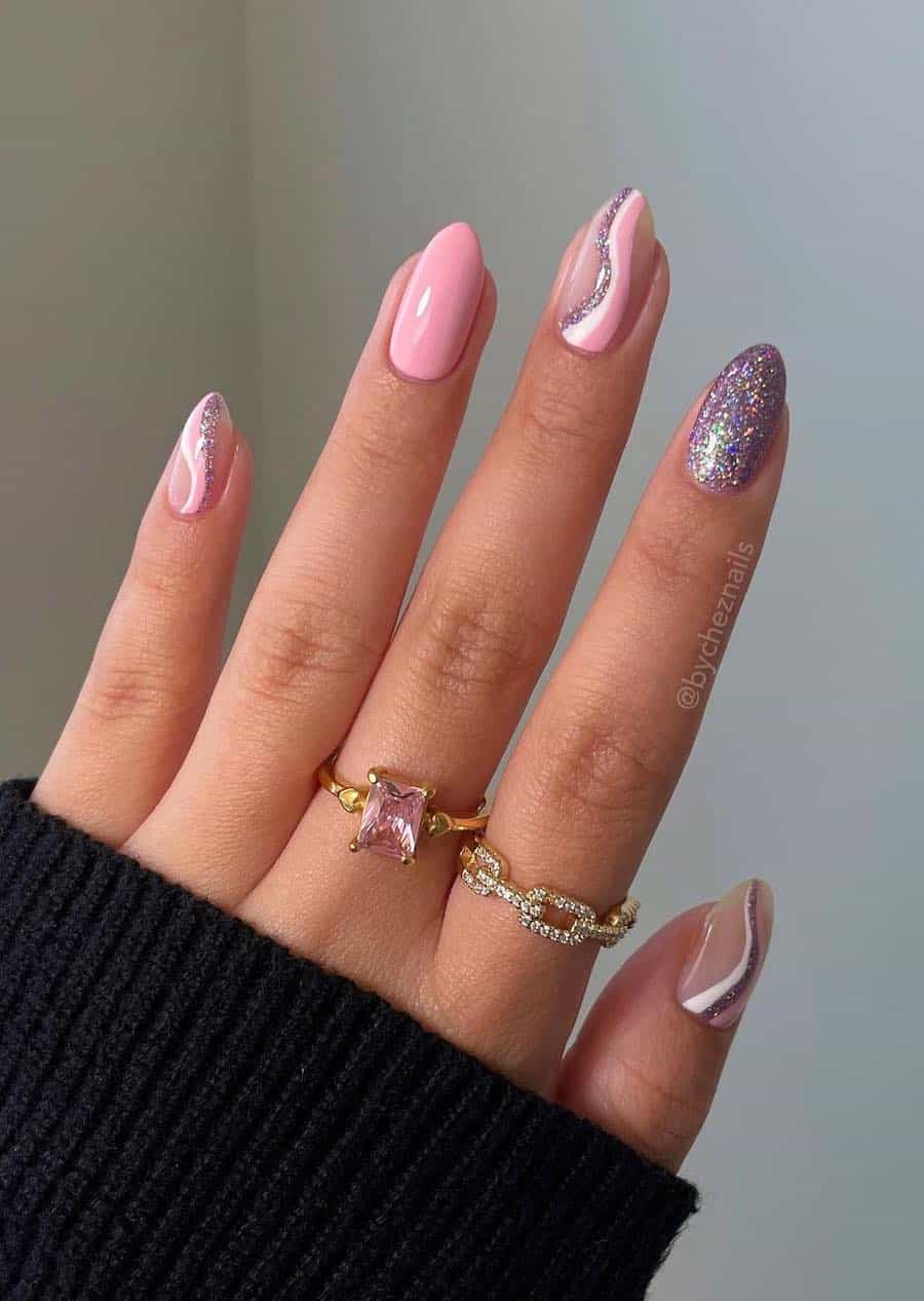 Short almond nails painted with glossy pink and glittering silver polishes with wave accent nails
