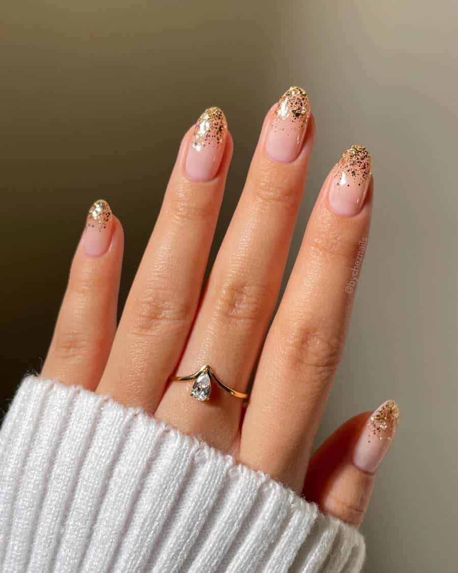 Short nude round nails with gold glitter ombre tips