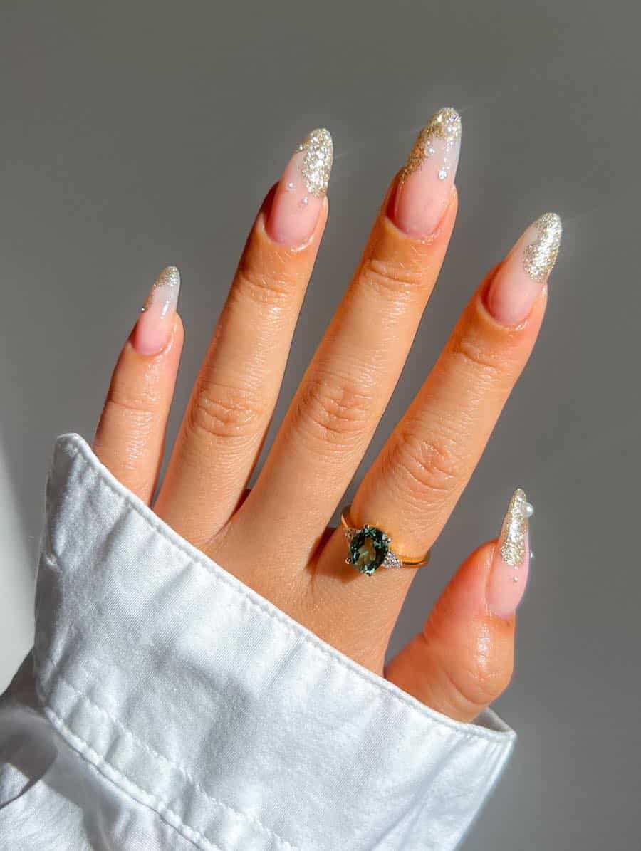 Long nude almond nails with wavy silver glitter tips with dripping effects and pearls