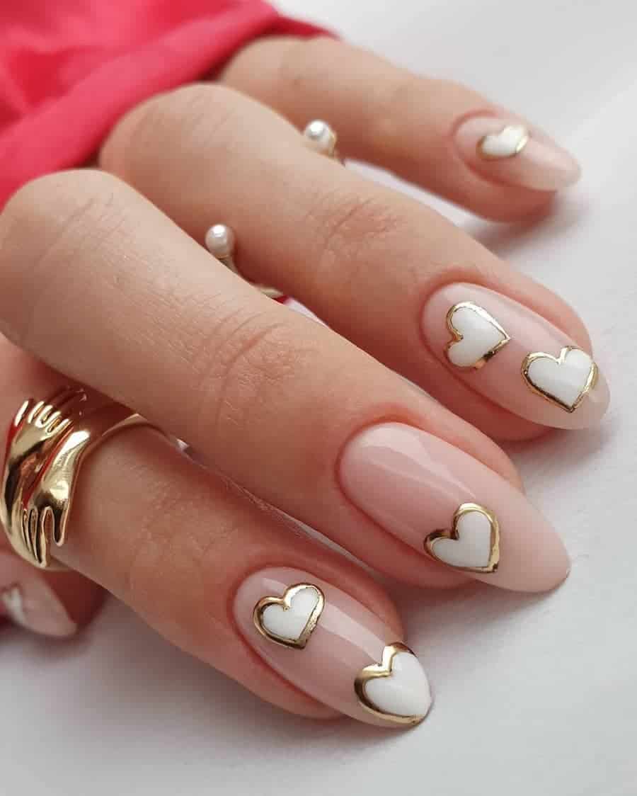 Medium pastel pink almond nails with white hearts with metallic gold borders