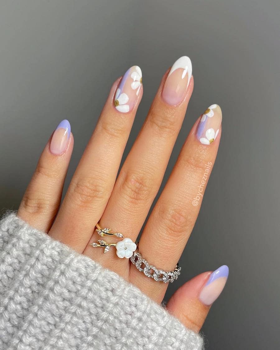 Medium nude almond nails with white and purple tips and floral accent nails