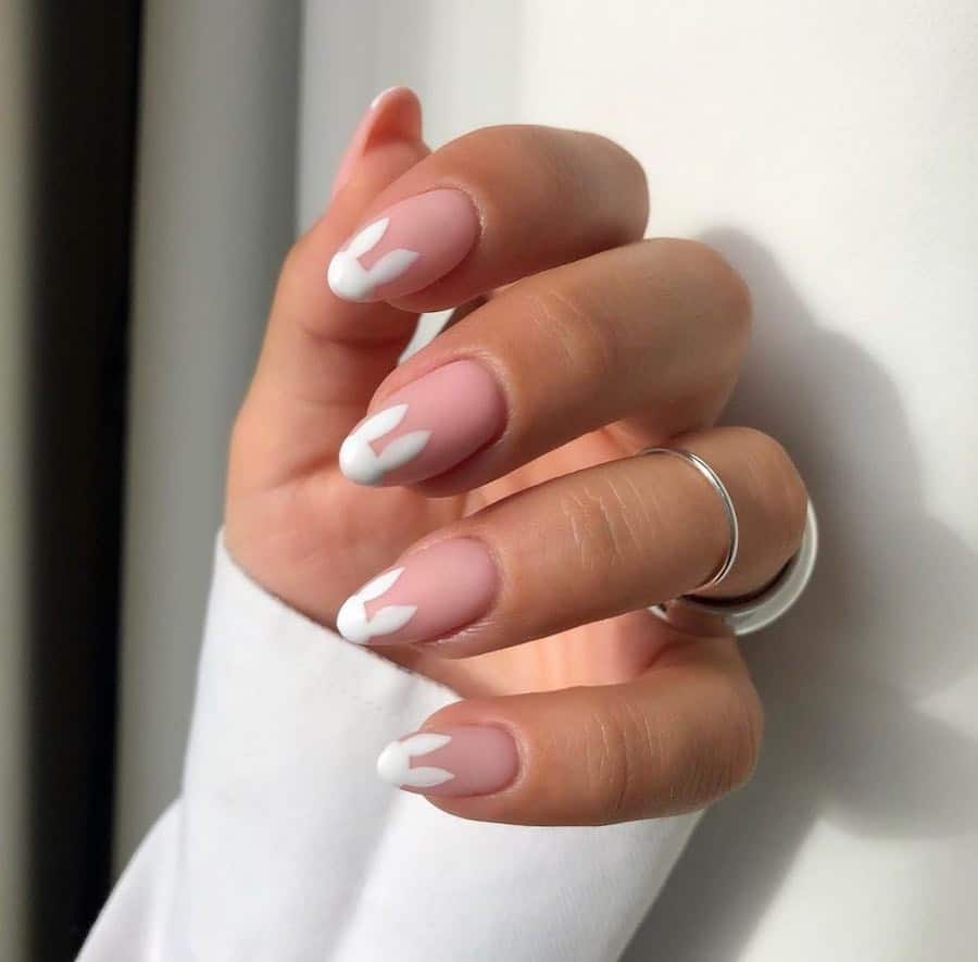 Medium matte nude almond nails with white bunny ear tips
