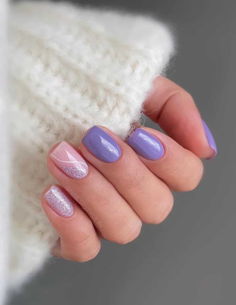Short square light purple nails with two accent nails, one with a light purple glitter and one with a glitter wave and a white line accent