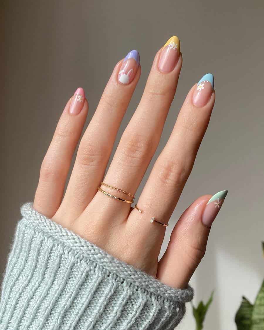 Short almond nails with gradient pastel tips, floral accents, and a peekaboo bunny