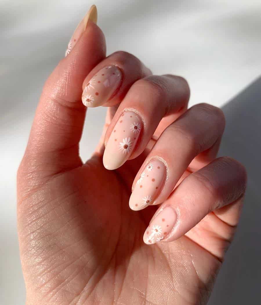 Long nude almond nails with white floral art and brown dots
