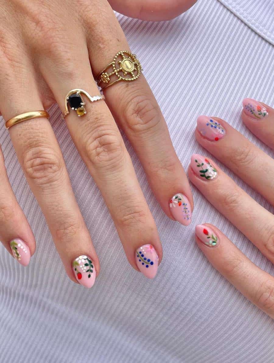 Short pastel pink almond nails with spring floral and botanical art