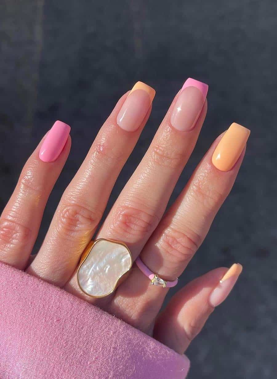 Short square nails with light pink and peach French tips and solid-colored nails