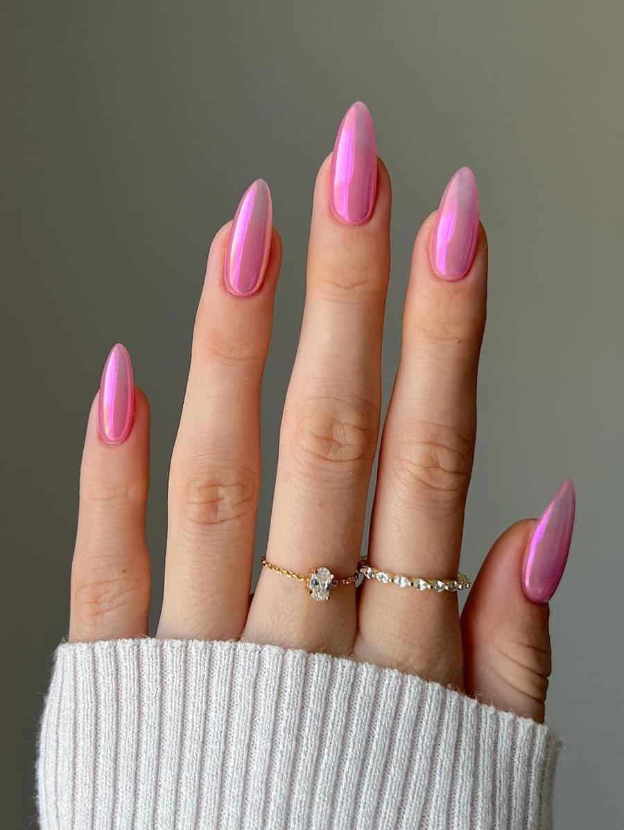 Long almond nails with pink jelly polish and a chrome finish