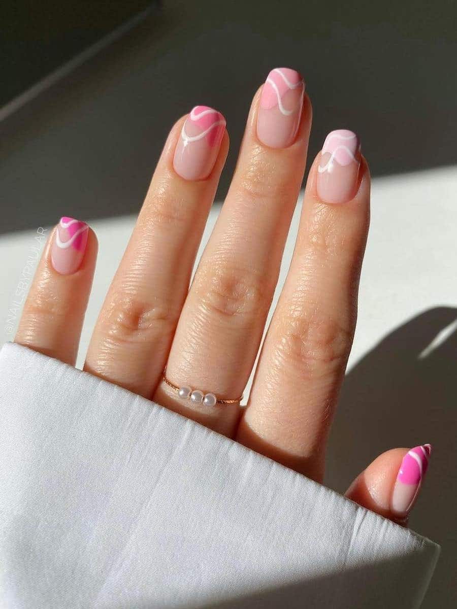 Short squoval nude nails with ombre pink waves and white swirl lines
