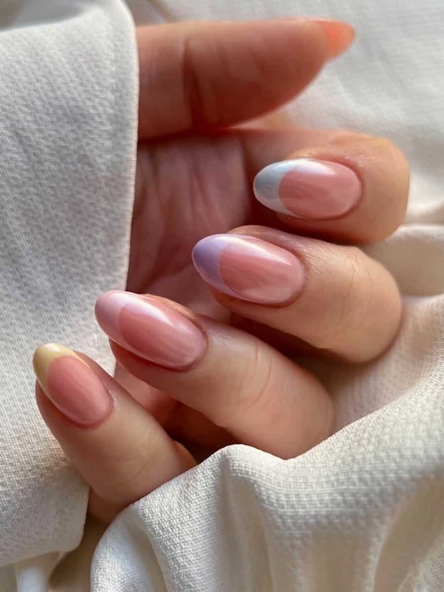 Short nude almond nails with pastel gradient French tips and a chrome finish