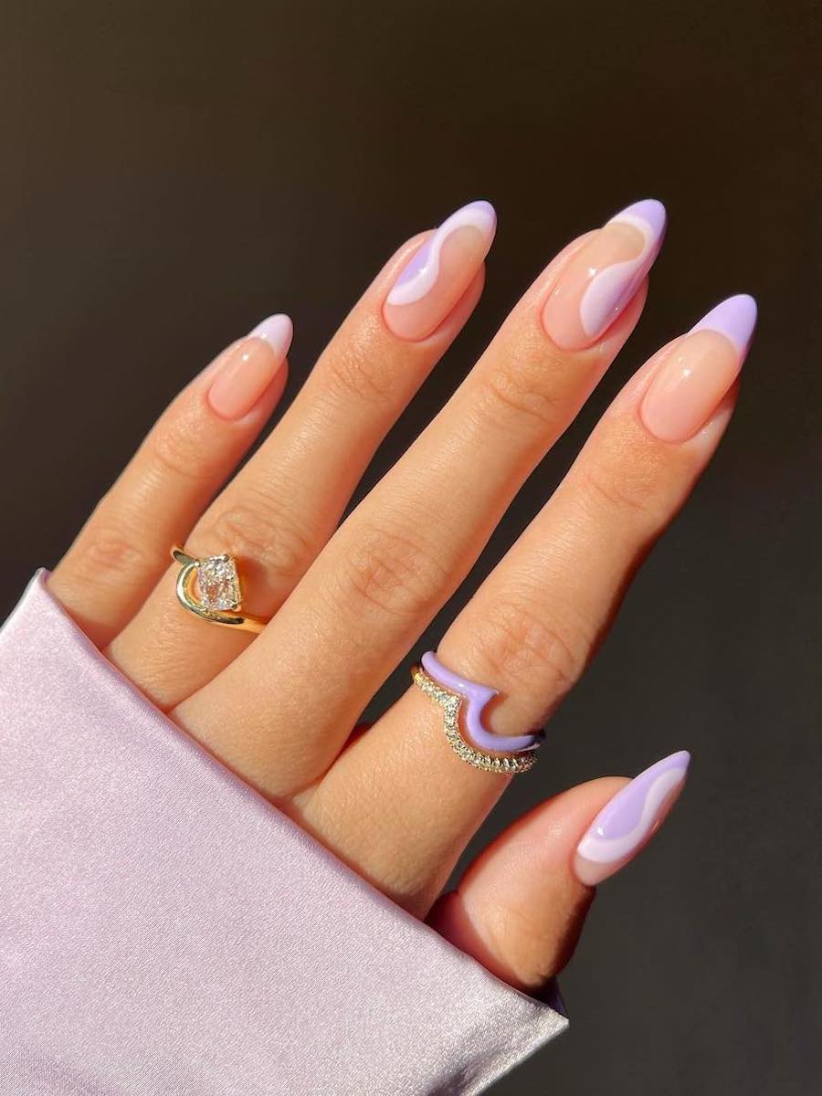 Medium nude glossy almond nails with pink and purple French tips and pink and purple waves