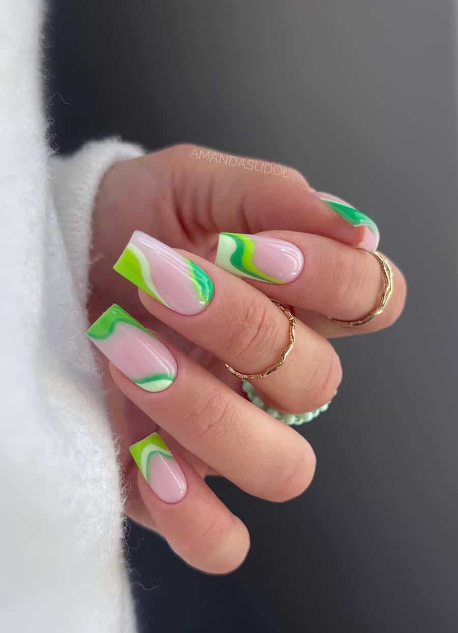 Long glossy nude square nails with light, medium, and dark green swirls