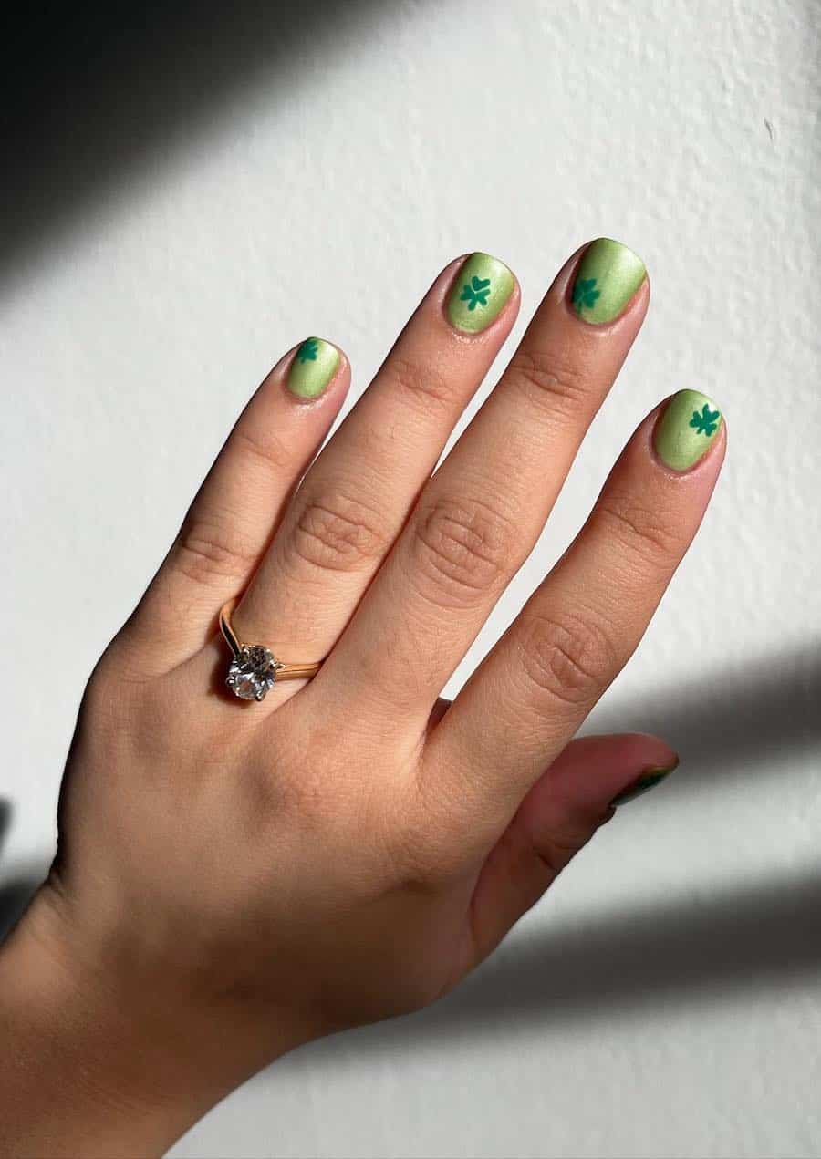Short green chrome nails with four leaf clover nail art