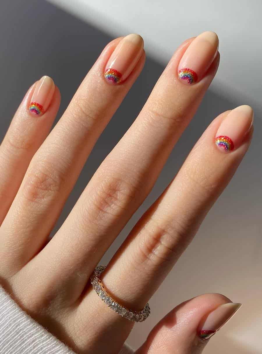 Short nude almond nails with glittering rainbow half moons