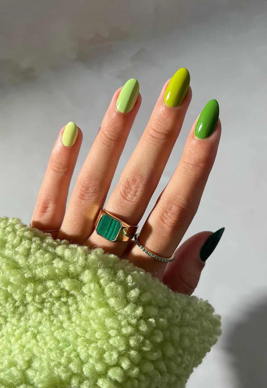 Short almond nails with gradient green polish