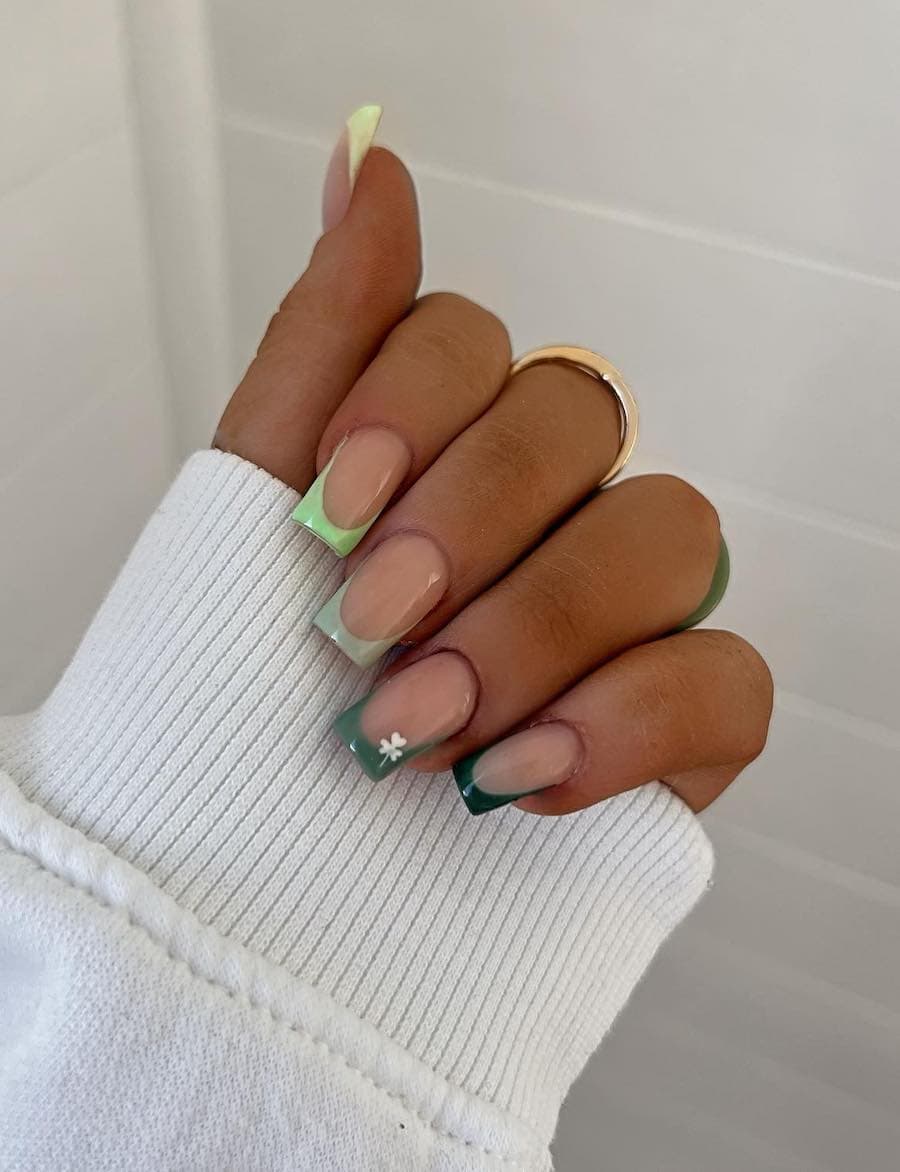 Medium nude square nails with gradient green tips and a white clover accent