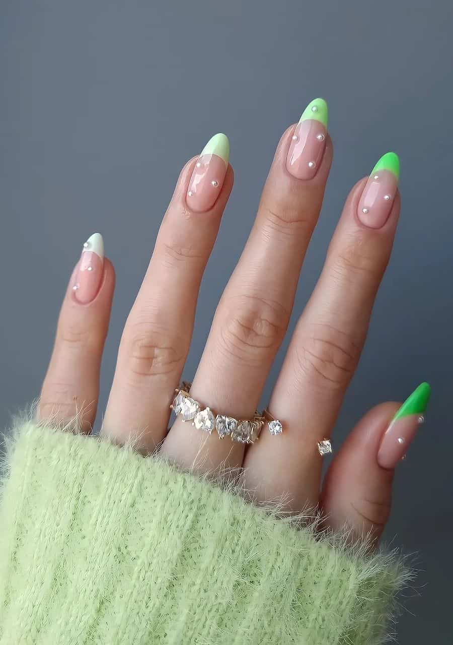 Medium nude almond nails with gradient green French tips and pearls