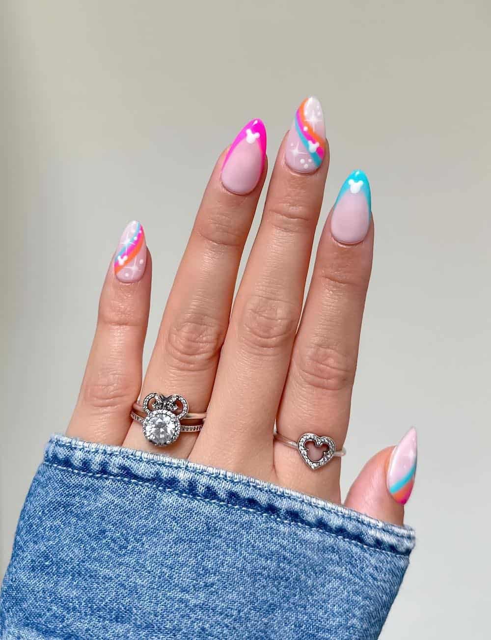 Medium almond nails with a Mickey Mouse design featuring colorful tips and waves