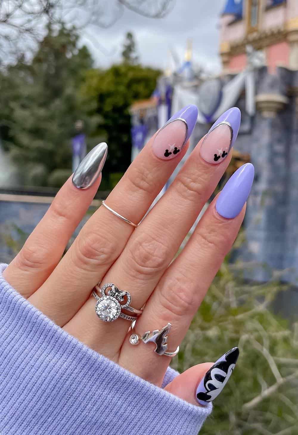 Medium almond nails with a Mickey Mouse design featuring soft purple and metallic silver polish and black and white nail art
