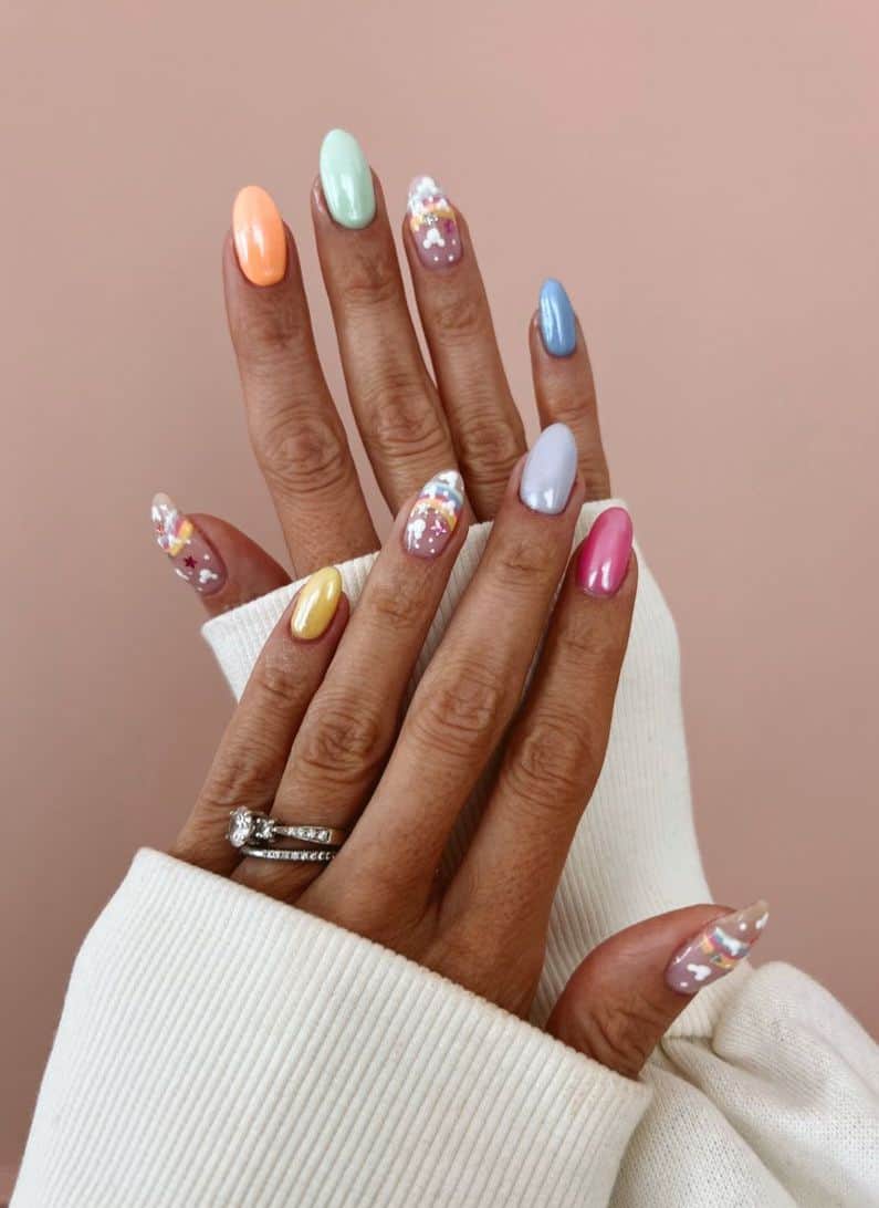 Medium almond nails with a Mickey Mouse design featuring colorful nails, rainbow art, and Mickey silhouettes