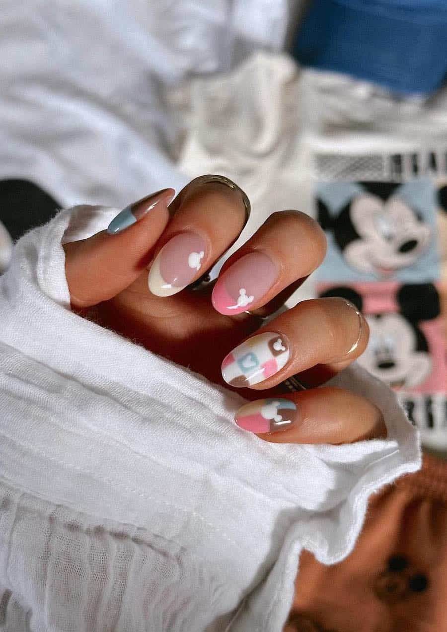 Medium almond nails with a Mickey Mouse design featuring colorful polish and checkerboard accents