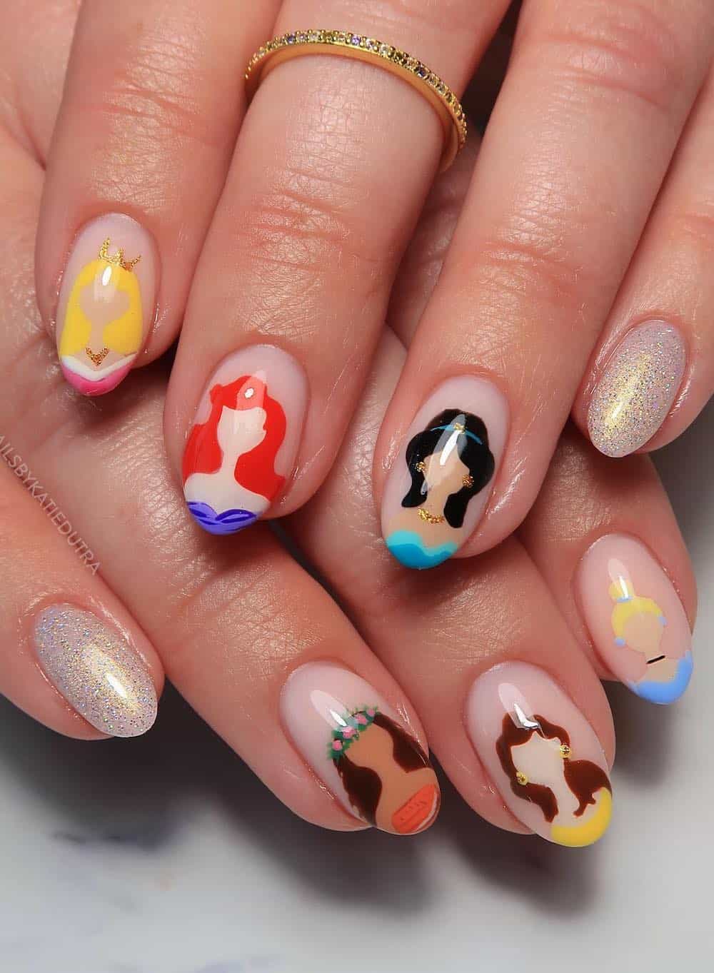 Short almond nails with a Disney design featuring simple princess nail art
