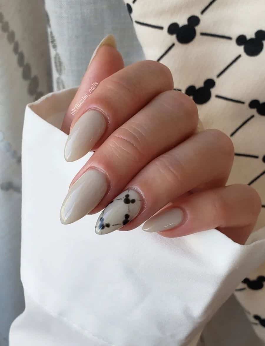 Medium almond nails with a Mickey Mouse design featuring off-white polish and a diamond Disney pattern