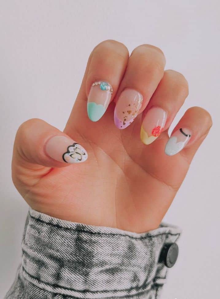 Medium almond nails with a Disney design featuring colorful princess inspired nail art tips