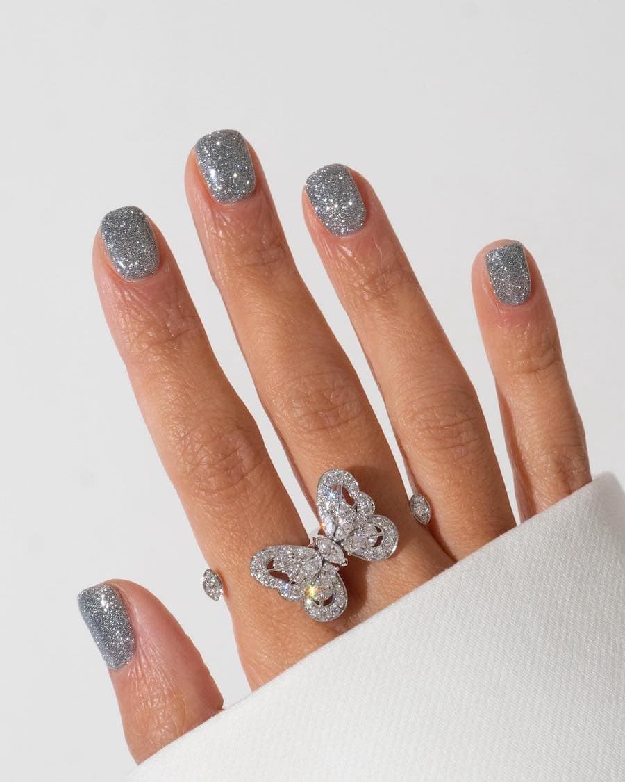 Short squoval nails with silver glitter polish