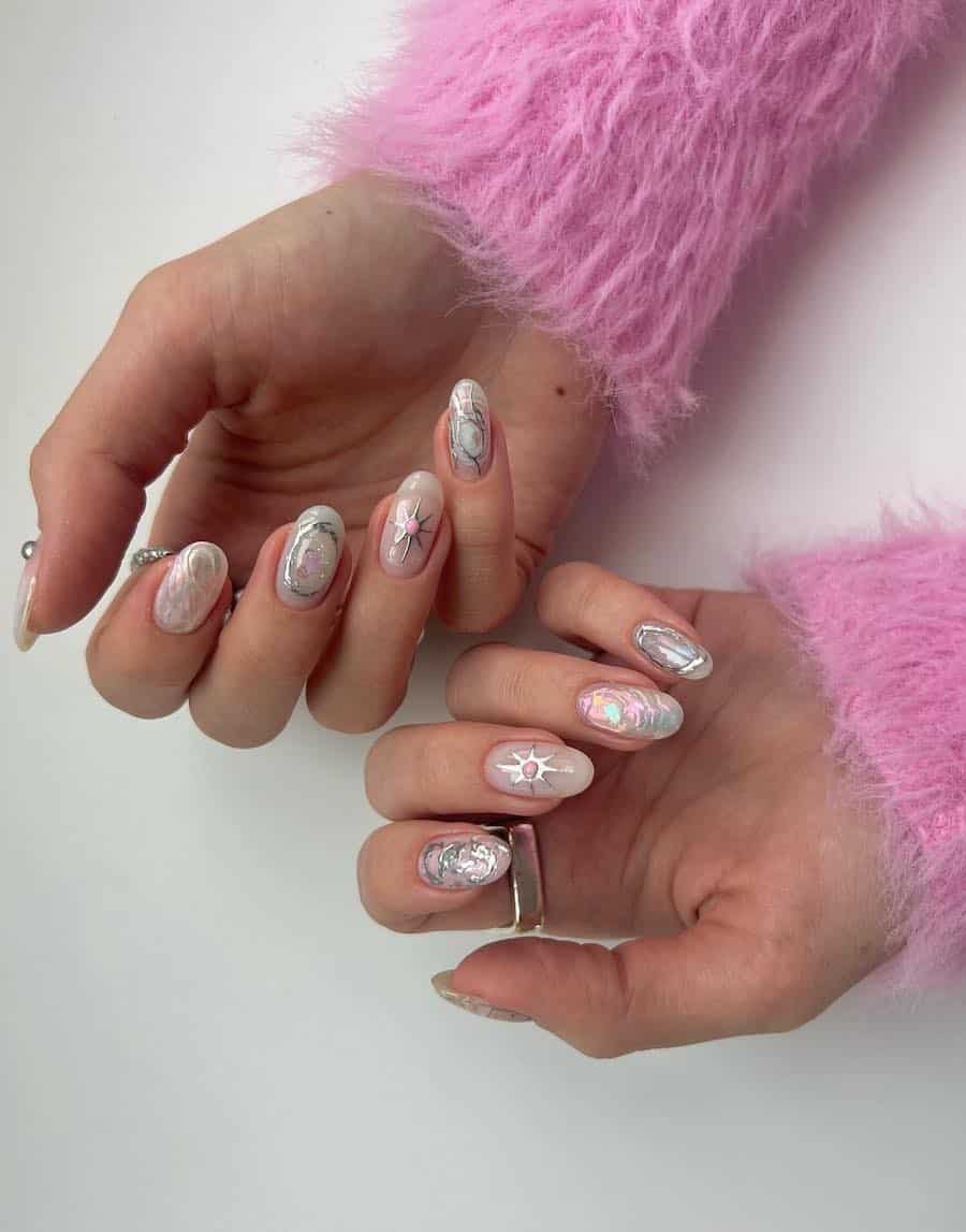 Short round nails with a shimmering white polish and silver nail accents