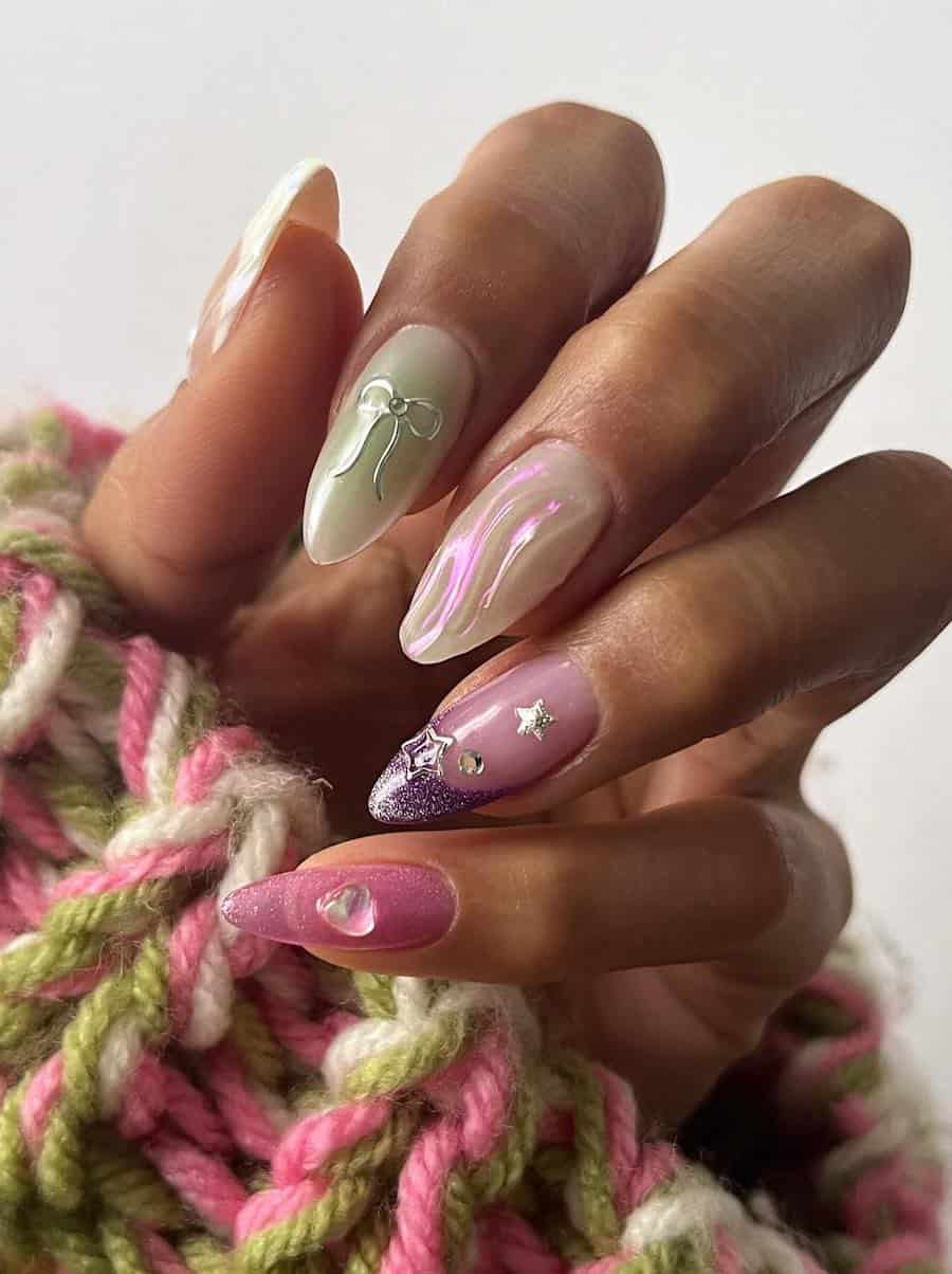 Long almond nails painted in a collage fairy core design