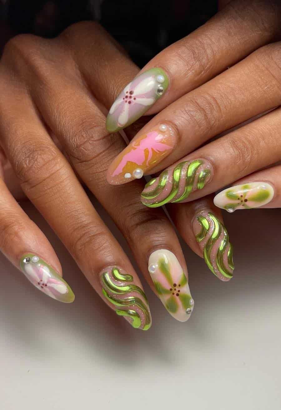 Long almond nails with 3D nail art, fairy silhouettes, and floral accents
