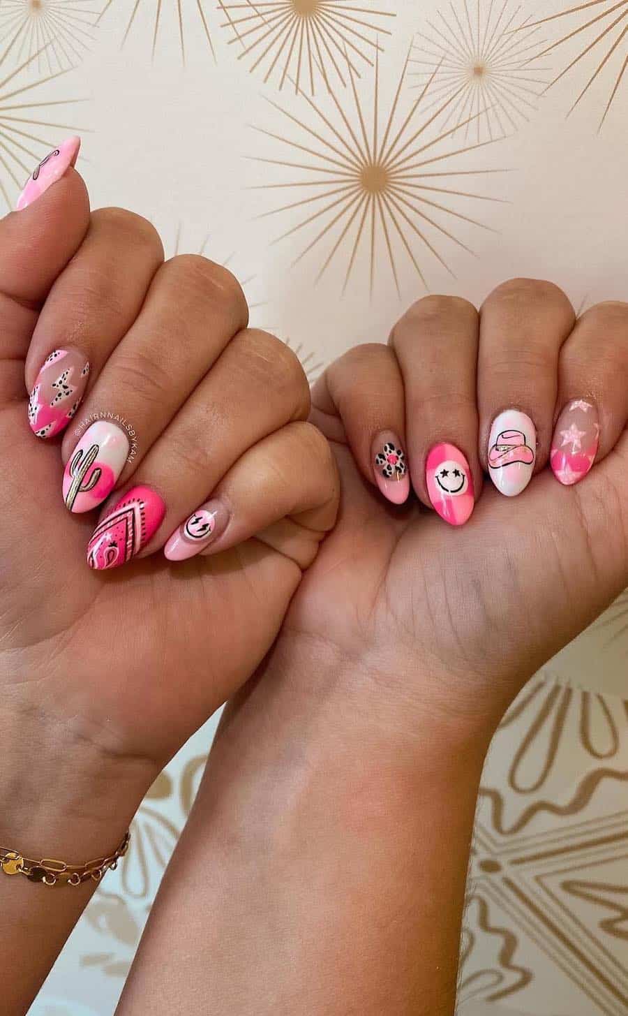 Medium almond nails featuring pink and white Western collage style designs