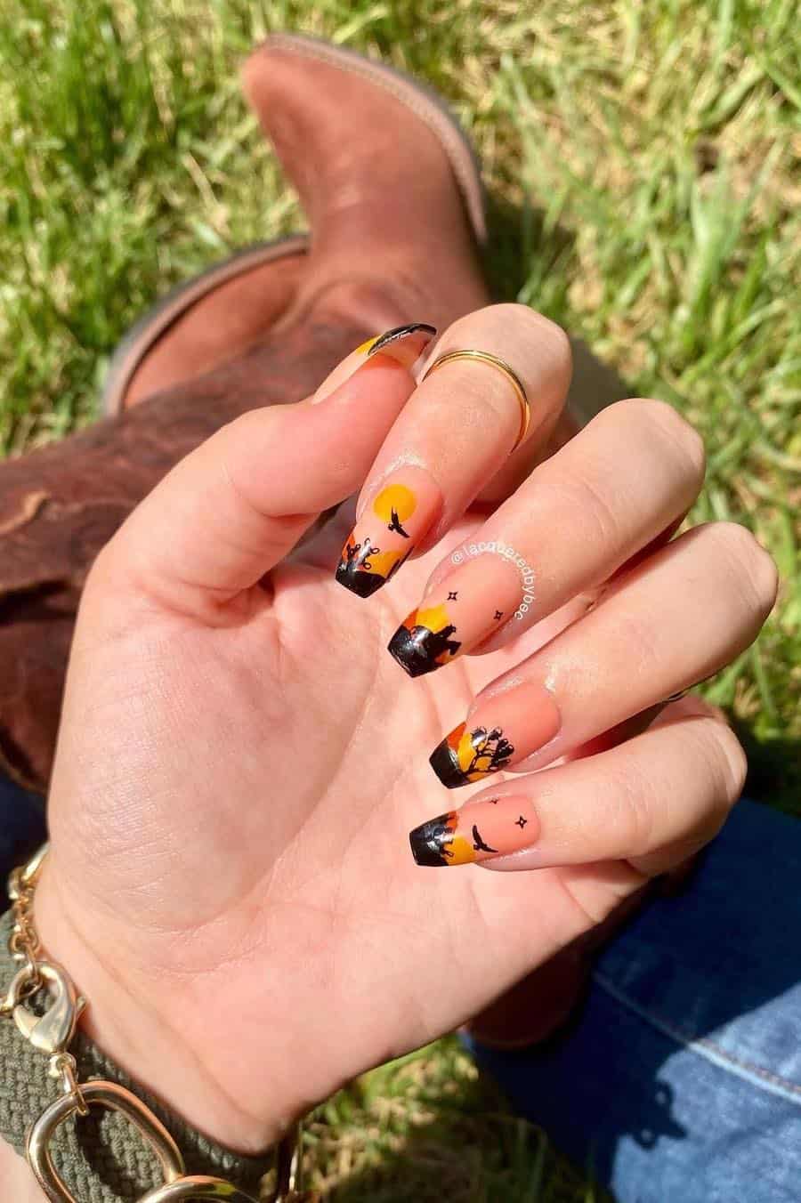 Long coffin nails featuring a sunset design with Western-inspired silhouettes