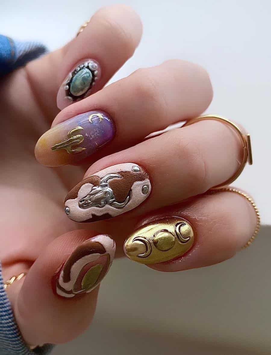 Short round nails featuring Western-themed designs such as cow print, cactus, and skulls